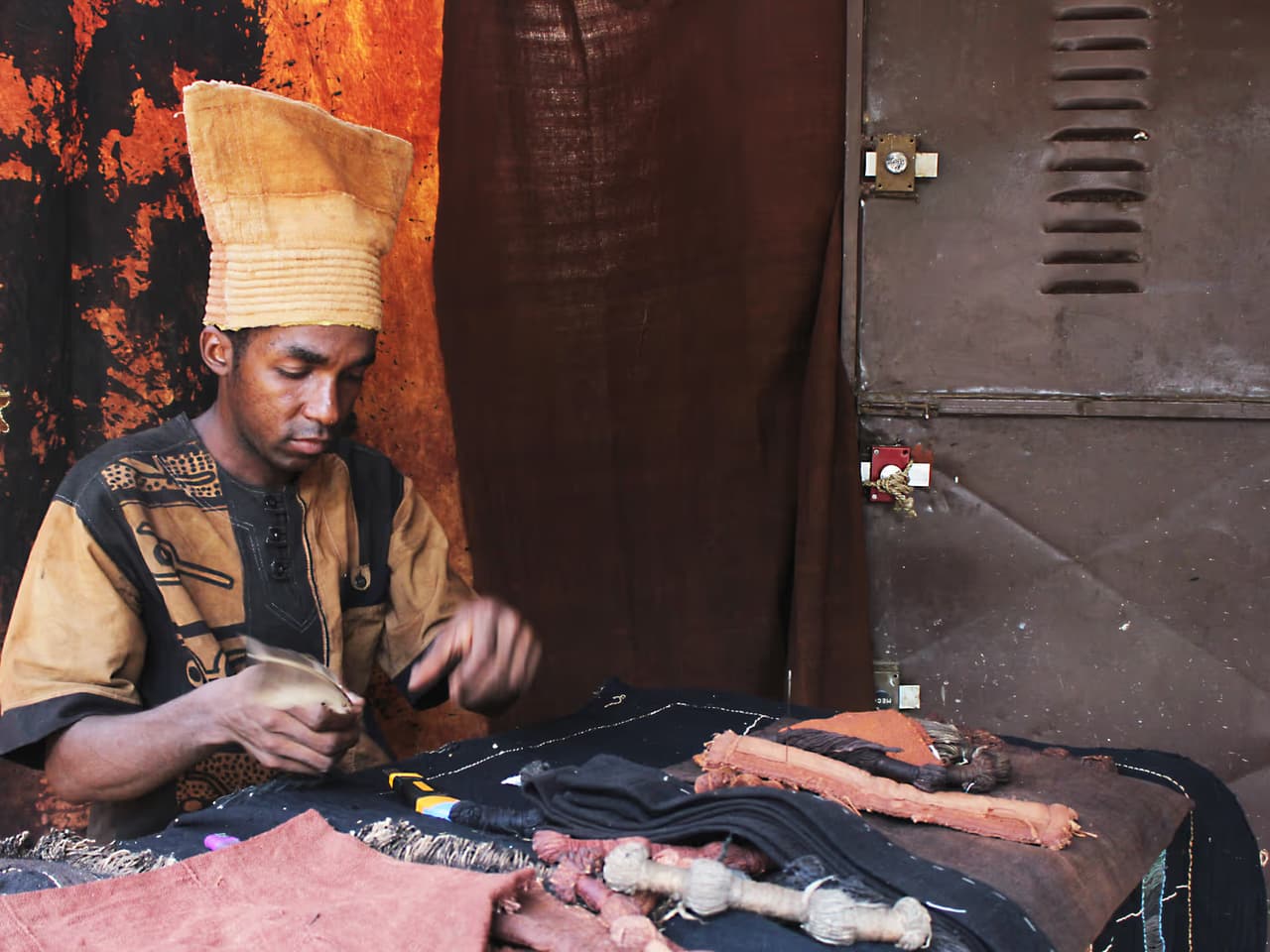 bazin teint bissap — Un artisan travaillant du bogolan